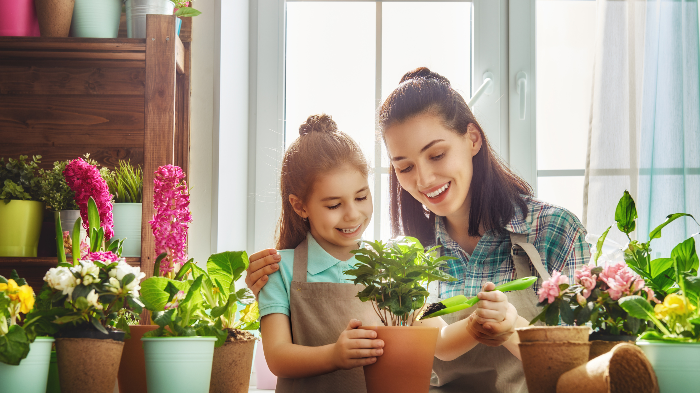spring summer transitions blog image 2 woman and girl potting flowers together smiling