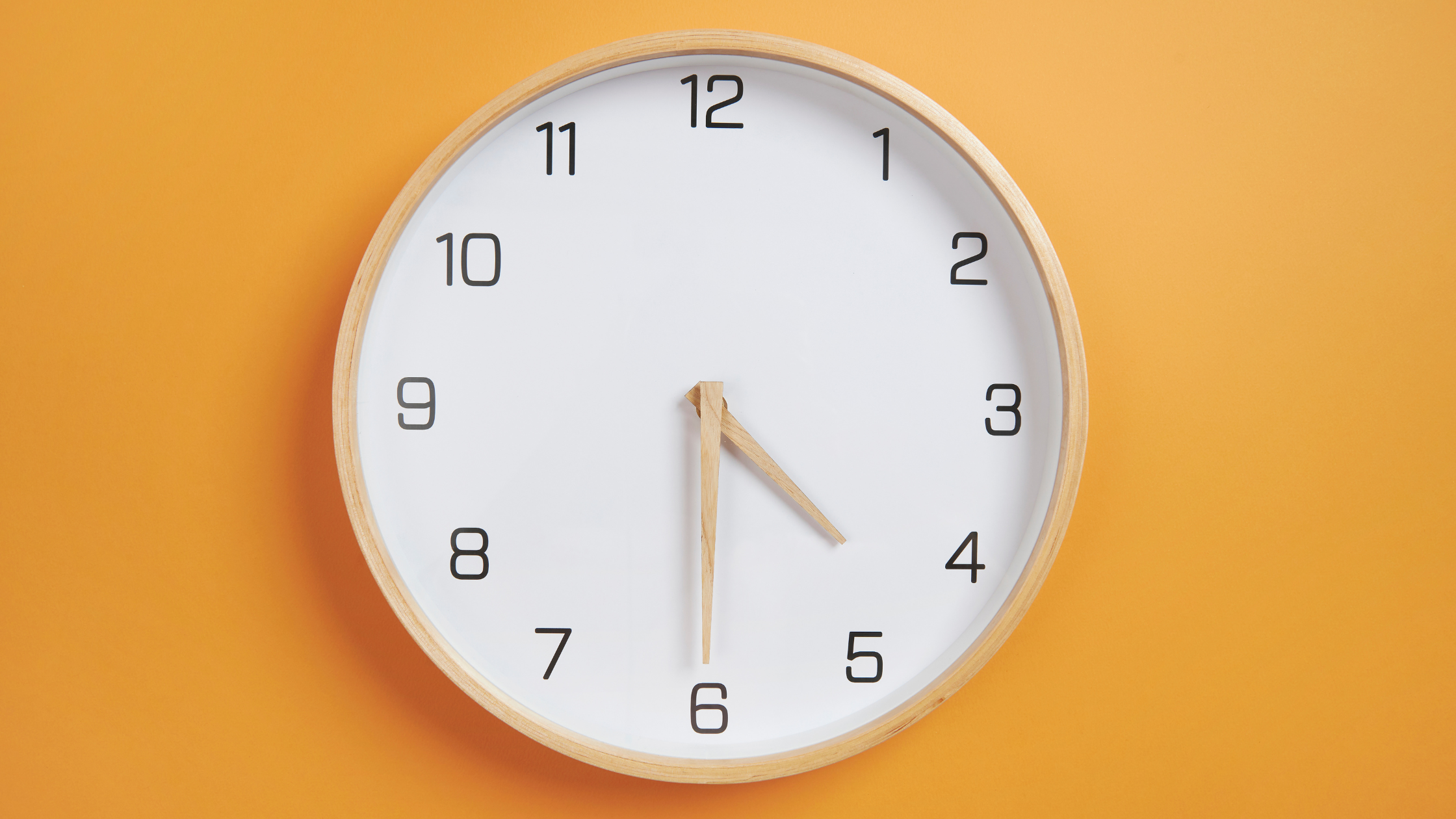 estimation updated blog image 2 orange background and wooden clock