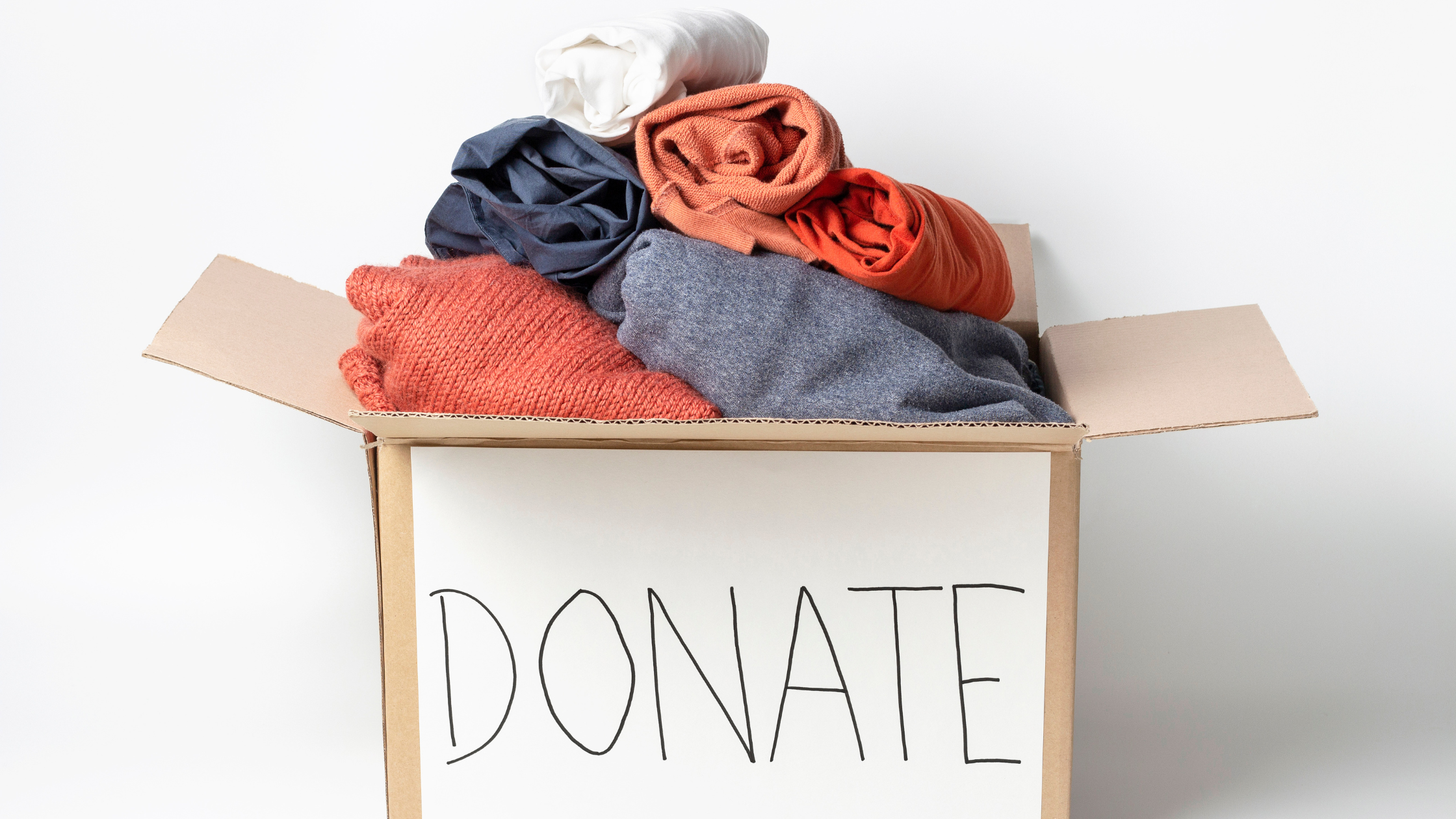 creating a donation bin blog image 2 cardboard box with donate on it and clothes inside
